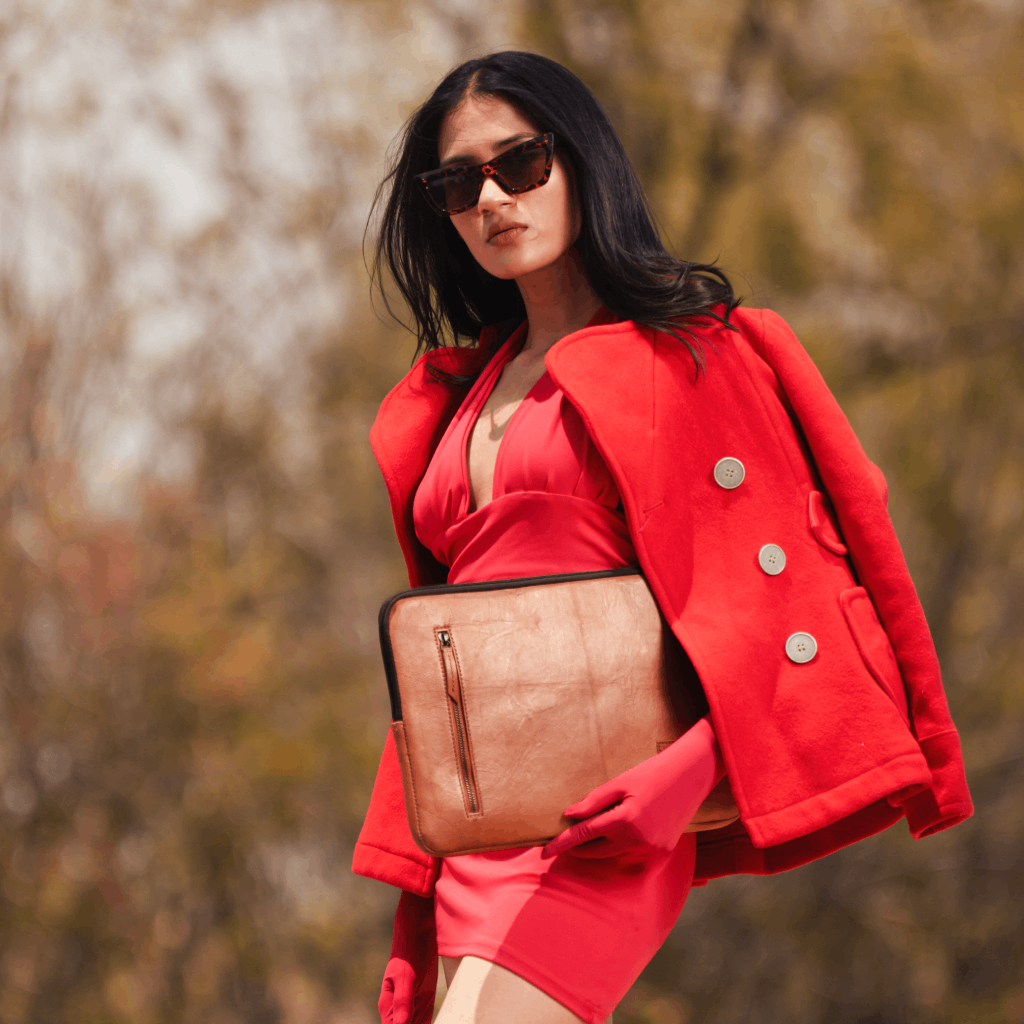 Woman carrying a brown full-grain leather laptop sleeve