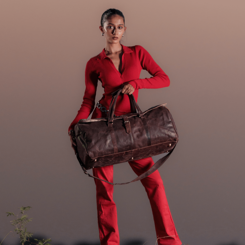 Woman carrying a brown full grain leather duffle bag