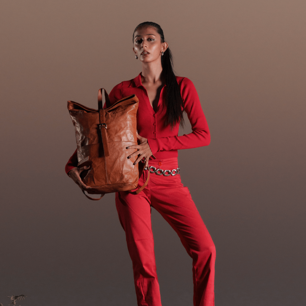Woman carrying Havynhide Dhoni full grain leather backpack