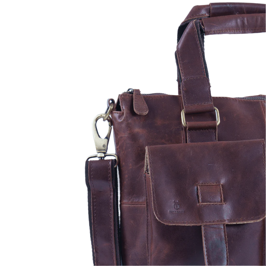 Side view of brown leather messenger bag with shoulder strap